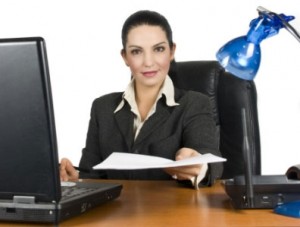 Woman with paper at desk